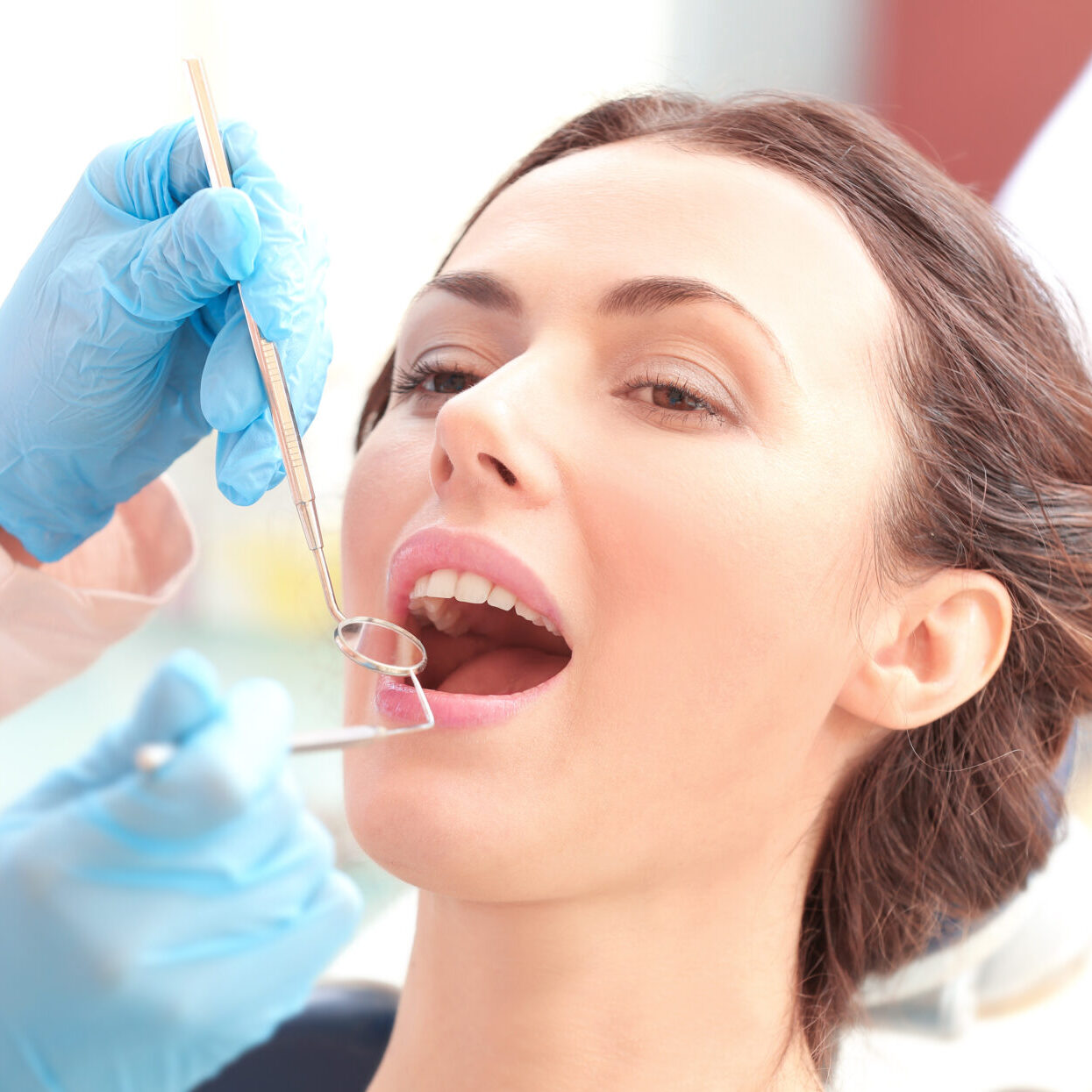 Dentist Examining Patient's Teeth In Clinic Dentist Examining Patient's Teeth In Clinic